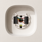White contoured Ecobee Premium drywall niche showing the thermostat mounting backplate and wiring before the face is fitted