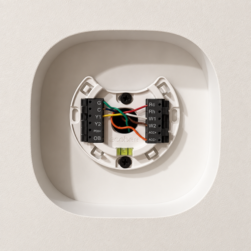 White contoured Ecobee Premium drywall niche showing the thermostat mounting backplate and wiring before the face is fitted