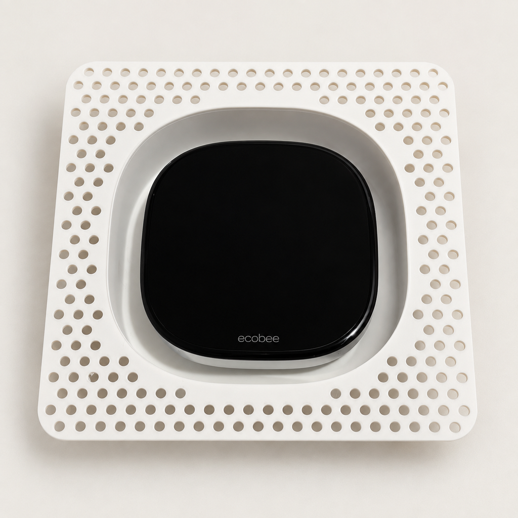White Ecobee Premium contoured niche before installation, showing its perforated square mud-in flange and thermostat fit