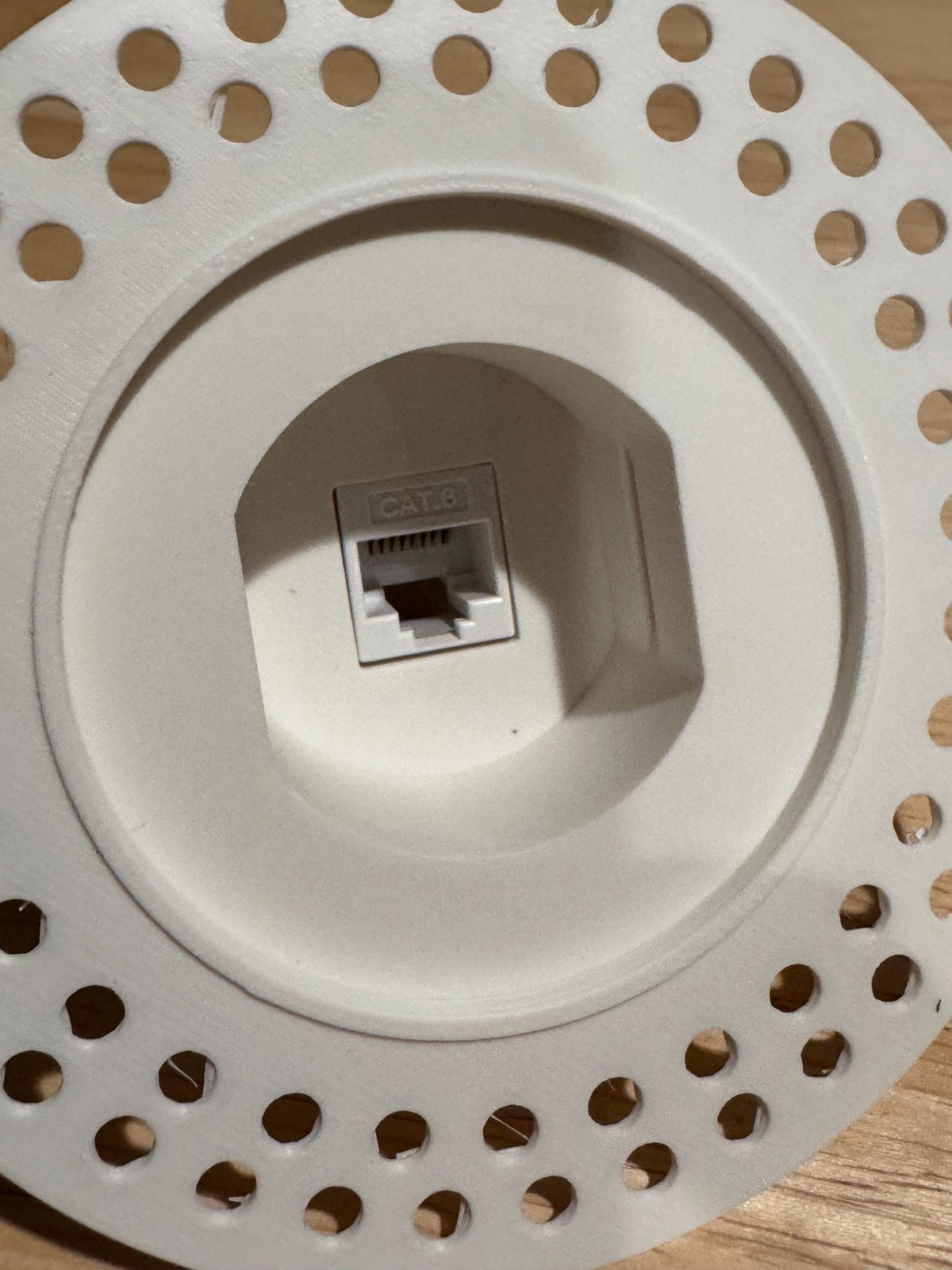 Front view of the integrated keystone jack mount inside the round Cat6 wall niche