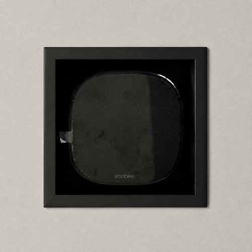 Ecobee Premium thermostat installed in a black recessed drywall mount with a solid visible frame