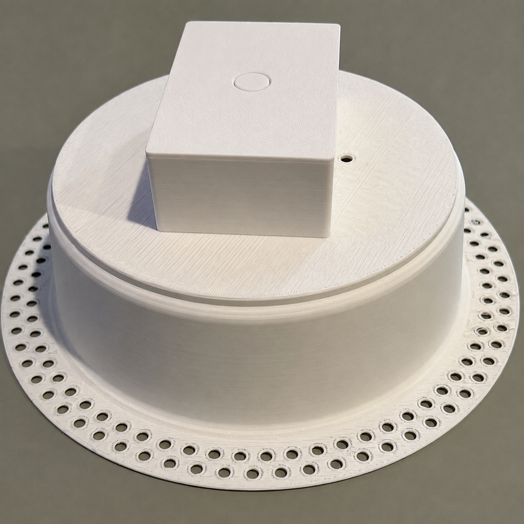 Rear/top view of the white round trimless drywall mount with the optional integrated low-voltage rear enclosure.