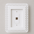 White trimless recessed low-voltage wall plate enclosure with perforated mud-in flange