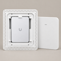 Front-facing product render of the white Maker Is UniFi U7 Pro Wall flush drywall mount, showing the access point and removable cover. Access point not included.